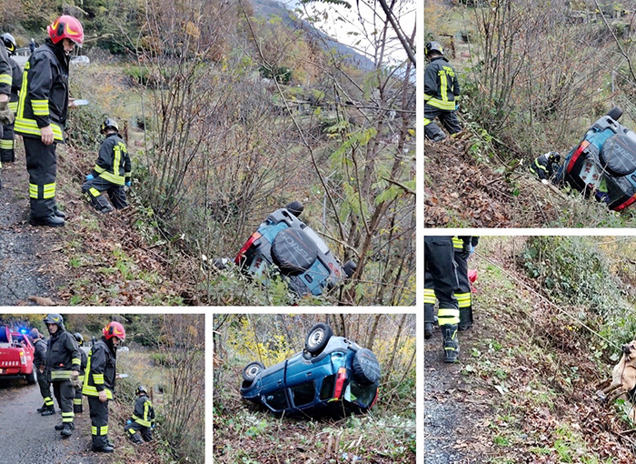 Jeep cappottata e fermata dagli alberi prima del precipizio. Salvati sia l'autista che il suo cane. Foto